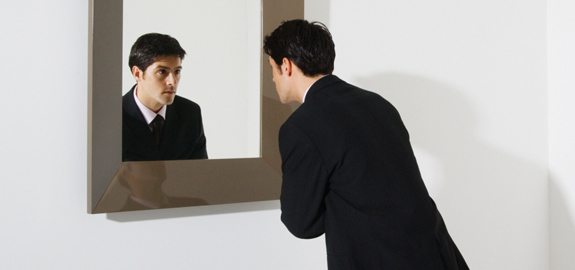 Businessman Looking in Mirror