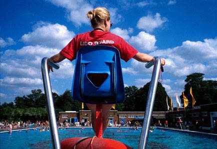 A lifeguard watching over a pool.
